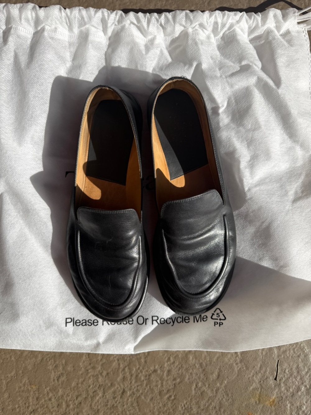The Row Black Leather Penny Loafers